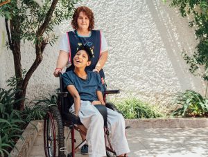 Practical nurse with patient in wheelchair